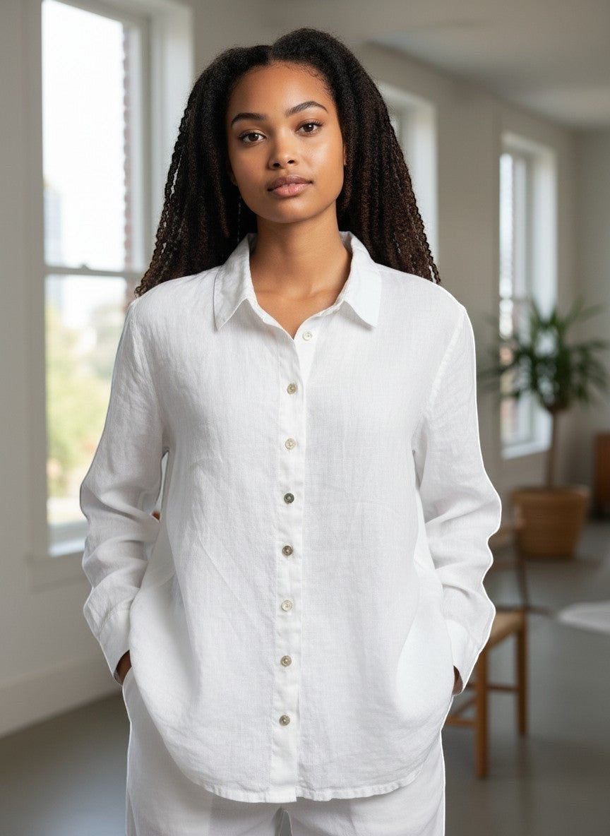 Woman wearing a white shirt in a bright room with large windows