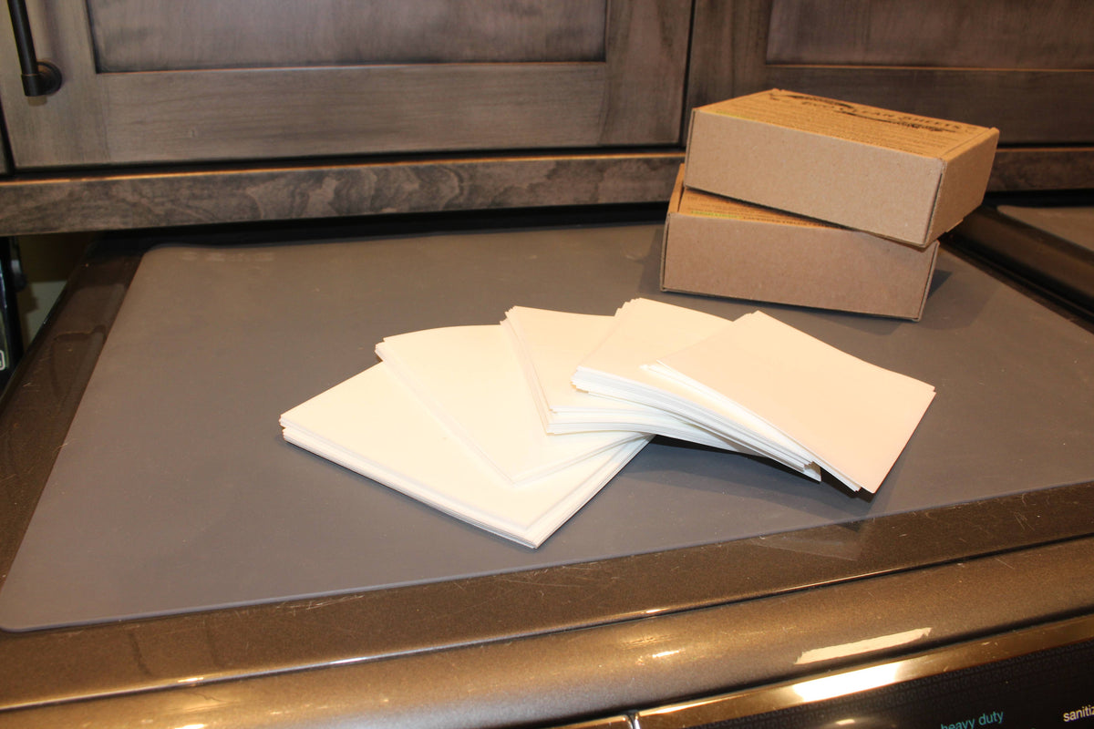 White cloths on a metallic surface with a cardboard box in the background