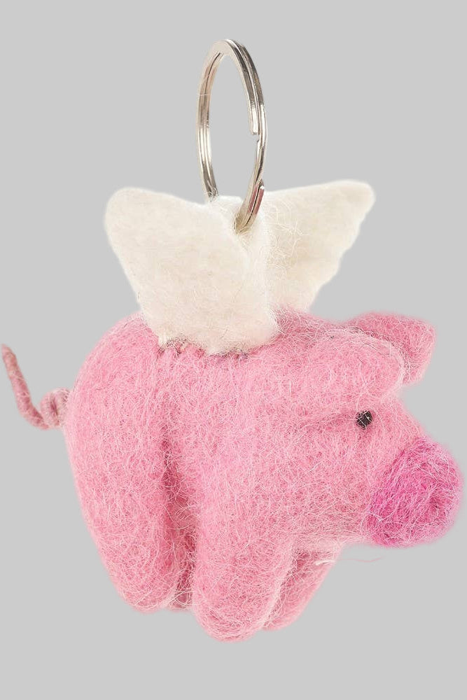 Pink pig keychain with white wings on a white background
