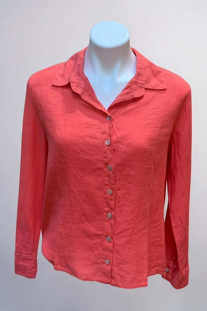 Natural Clothing Company coral pink long-sleeve linen button-down blouse on a mannequin